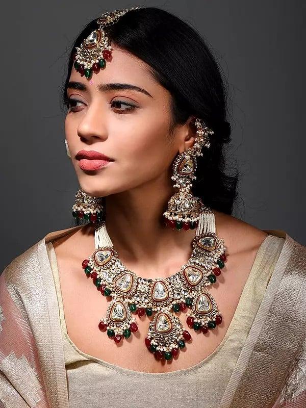 exotic india Kundan Studded and Beaded Necklace Set with Mangtika and Earrings with Chain 