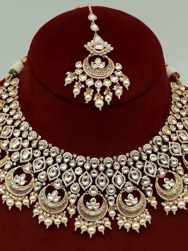 Exotic India Kundan Studded Brass Necklace Set For Women With Earrings And Mangtika