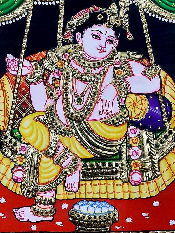 Exotic India Lord Krishna Seated On Swing | Tanjore Painting | Traditional Colors With Gold Work