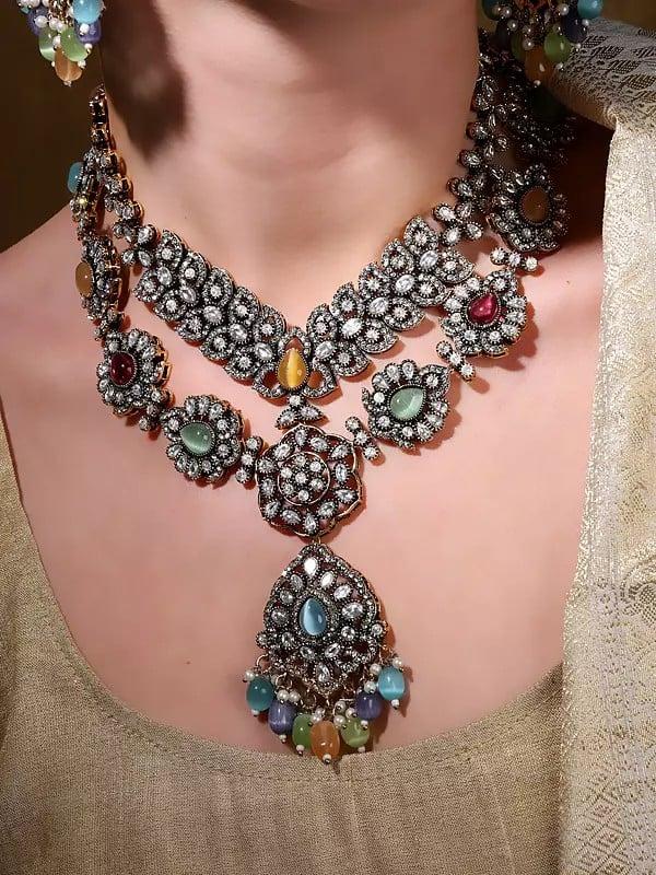Exotic India Multicolor AD Stone With Drop Beads Necklace With Earrings And Mangtika Set