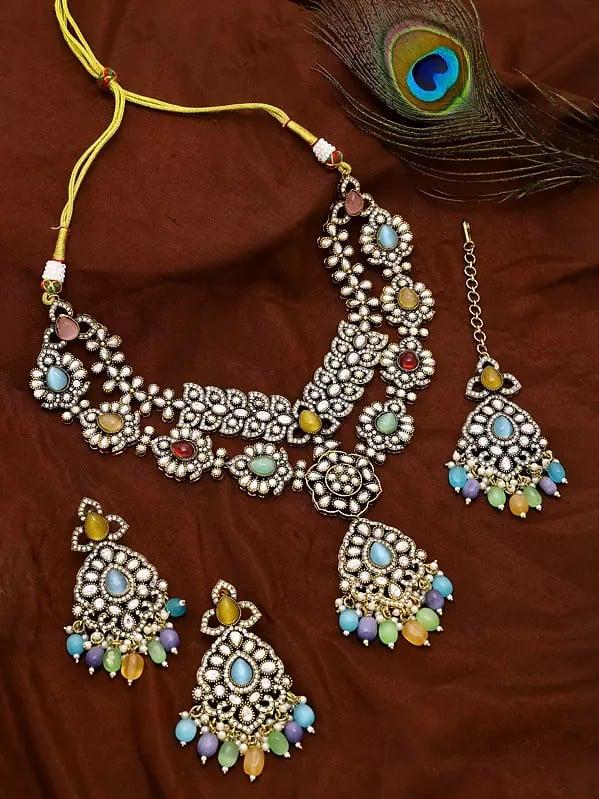Exotic India Multicolor AD Stone With Drop Beads Necklace With Earrings And Mangtika Set