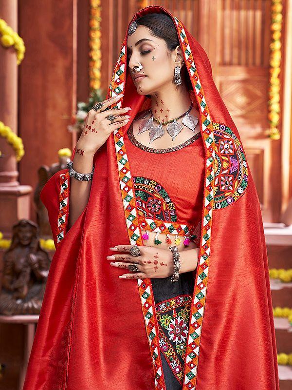 Exotic India Orange-Black Beautiful Traditional Lehenga Choli And Dupatta With Attractive Border Lace And Mirror Hand Work 
