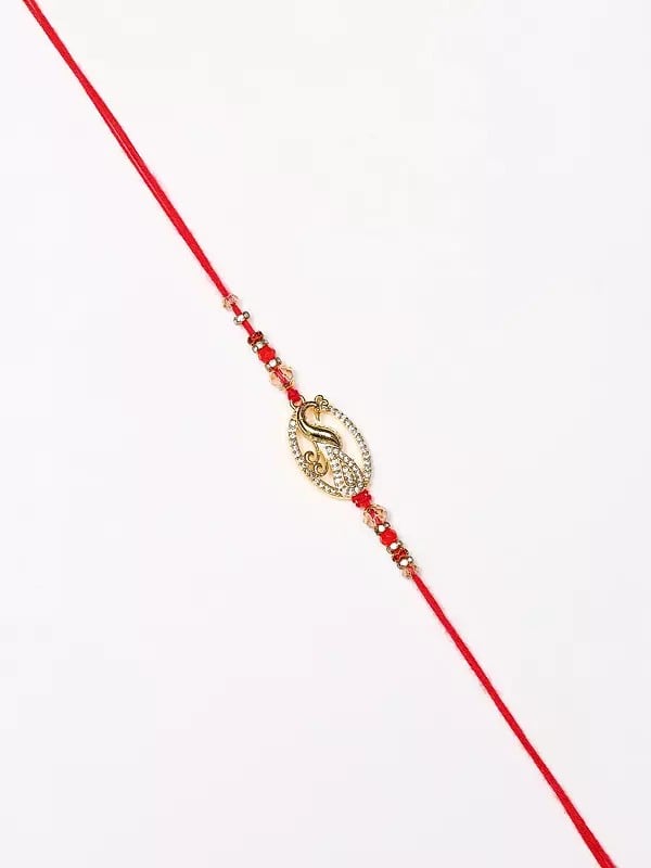 Exotic India Oval Shape Stone Studded Peacock Rakhi 
