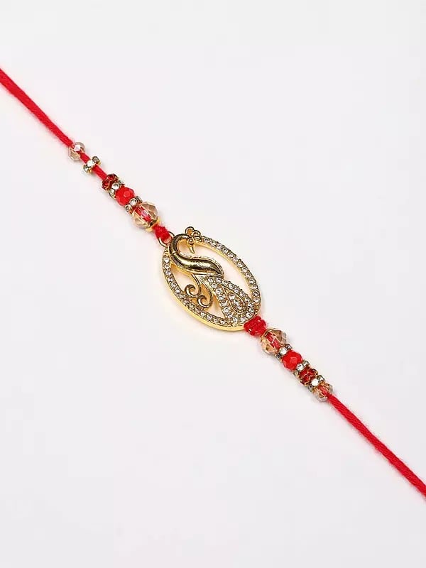 exotic india Oval Shape Stone Studded Peacock Rakhi 