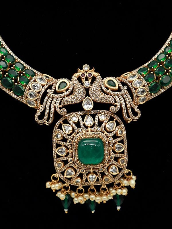 Exotic India Peacock Motif Moissanite Kundan With Matt Polish Necklace Set With Ruby Stones And Pearl Drops 