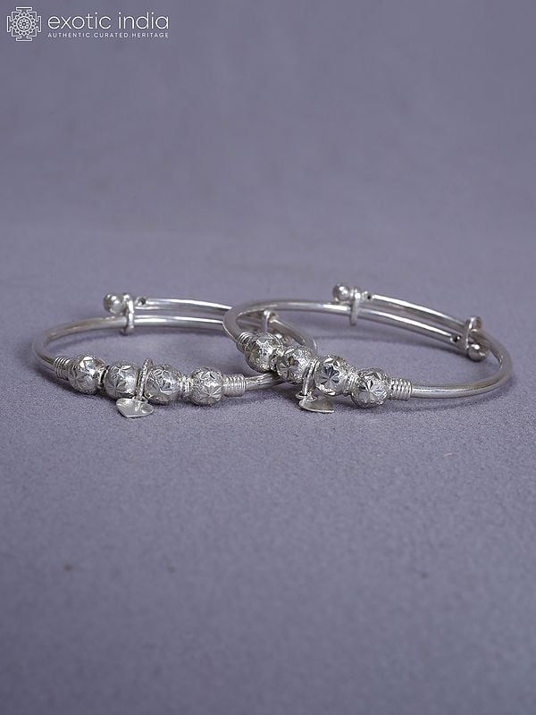 exotic india Pure Silver Set Of 2 Engraved Baby Bala From Nepal 
