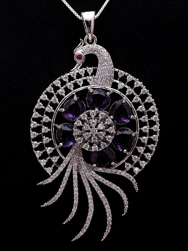 Exotic India Purple And White Stone Studded Peacock Pendant Set With Earrings