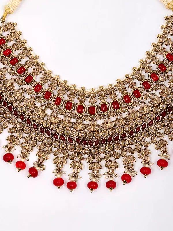 Exotic India Red And White Stone Studded Necklace Set With Earrings And Mangtika 