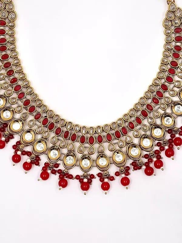 Exotic India Red And White Stone Studded Necklace Set With Earrings And Mangtika With Beads Drop 