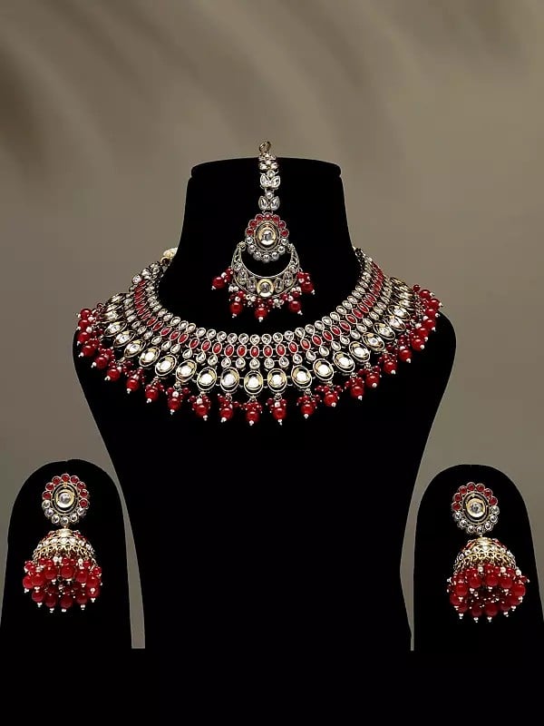 exotic india Red and White Stone Studded Necklace Set with Earrings and Mangtika with Beads Drop 