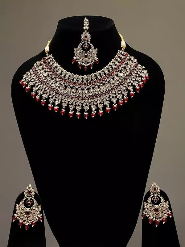 exotic india Red and White Stone Studded Necklace Set with Earrings and Mangtika 