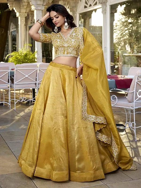 Exotic India Saffron-Mango Vichitra Silk Solid Attractive Lehenga Choli With Sequins And Embroidered Matching Dupatta 