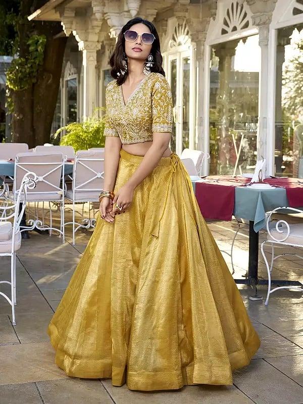Exotic India Saffron-Mango Vichitra Silk Solid Attractive Lehenga Choli With Sequins And Embroidered Matching Dupatta 