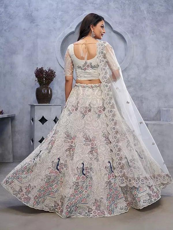Exotic India Soft Net Exquisite Sequins Work Peacock And Bagh Embroidery Fancy Wedding Wear Embellished Lehenga Choli With Attractive Dupatta 