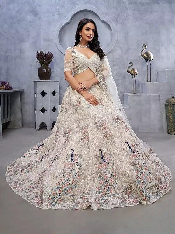 Exotic India Soft Net Exquisite Sequins Work Peacock And Bagh Embroidery Fancy Wedding Wear Embellished Lehenga Choli With Attractive Dupatta 
