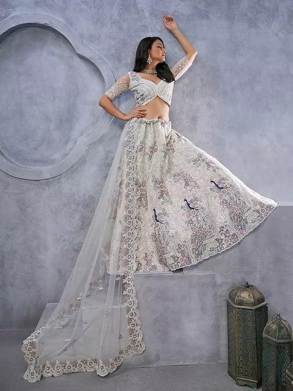 Exotic India Soft Net Exquisite Sequins Work Peacock And Bagh Embroidery Fancy Wedding Wear Embellished Lehenga Choli With Attractive Dupatta 