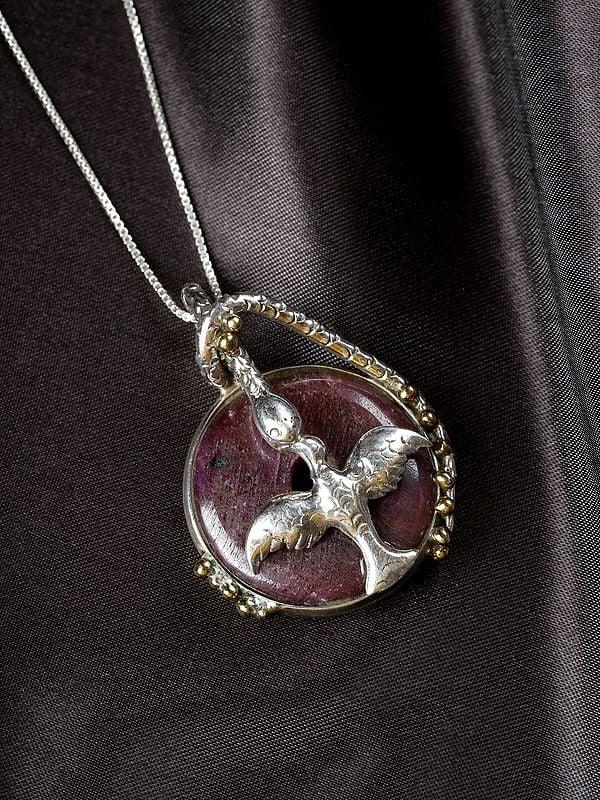 Exotic India Sterling Silver Bird Pendant With Round Raw Ruby