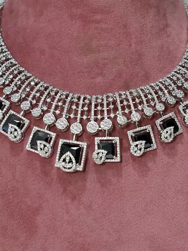 Exotic India Stone Studded American Diamond Necklace Set With Leaf Design Earrings