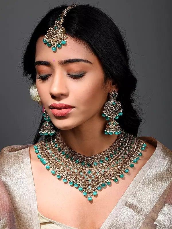 exotic india Stone Studded Necklace Set with Earrings and Mangtika with Drop Beads 