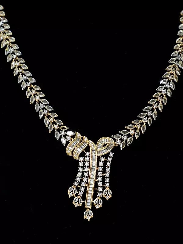Exotic India Stone Studded Unique Design Gold Polish Base American Diamond Necklace Set With Earrings