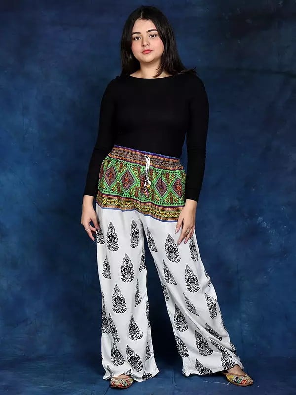 Exotic India White Bohemian Yoga Trousers With Gautam Buddha Print 