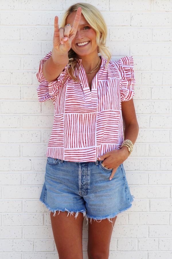 finley MENDED Remy Orange block stripe print blouse with ruffle sleeves