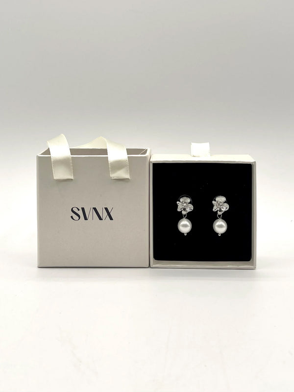 Goddiva Flower Drop Pearl Earrings In Silver By SVNX