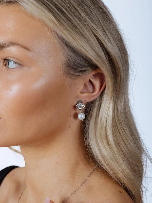 Goddiva Flower Drop Pearl Earrings In Silver By SVNX