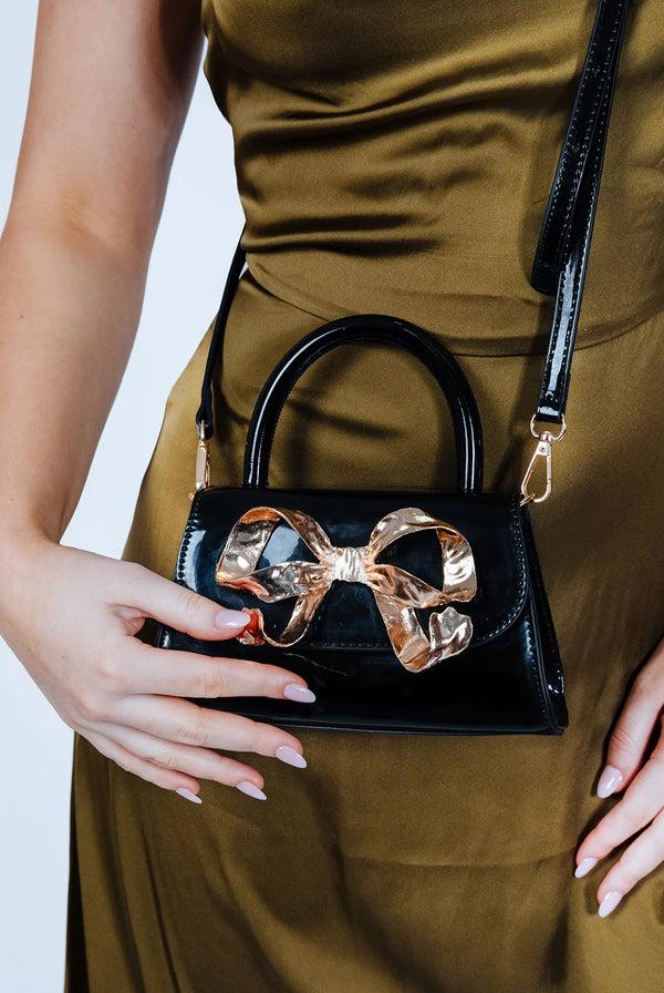 Goddiva Metallic Bow Top Handle Bag In Black By SVNX