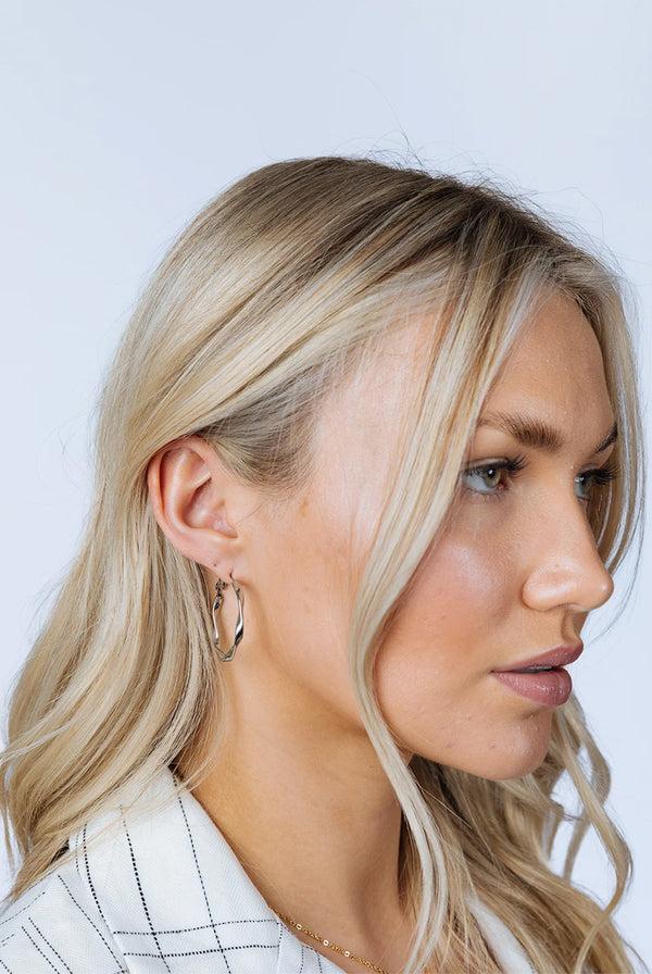 Goddiva Twist Hoops In Silver - Pouch Included By SVNX