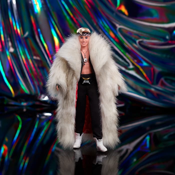 hot wheels Barbie The Movie Collectible Ken Doll Wearing Faux Fur Coat And Black Fringe Vest