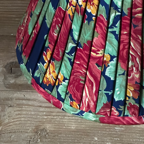 John Derian 14" Saved NY Pleated Fabric Lampshade #4122 Add To Cart Illuminate Your Space With The Bespoke Charm of This One-of-a-kind Hand-pleated Roller Print Fabric Lampshade In Shades Of Red Blue And Green. Crafted In Turke