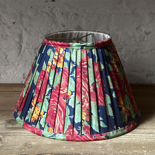 john derian 14" Saved NY Pleated Fabric Lampshade #4122 Add to cart Illuminate your space with the bespoke charm of this one-of-a-kind hand-pleated roller print fabric lampshade in shades of red blue and green. Crafted in Turke