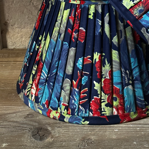 John Derian 14" Saved NY Pleated Fabric Lampshade Pair E Add To Cart Illuminate Your Space With The Bespoke Charm of This One-of-a-kind Hand-pleated Roller Print Fabric Lampshade In Shades Of Red Blue And Green. Crafted In Turk