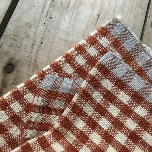 John Derian Gingham Tea Towel In Cognac & Blue Add To Cart Details 30" X 20" 100% Hand-Spun Linen Made In India Care Machine Wash Cold Gentle Cycle Tumble Dry. Do Not Bleach.   Caravan A Celebrated Home And Lifestyle Brand Emb