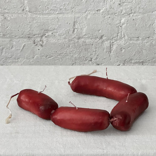 john derian Sausage Link Candle Add to cart Details 19" L x 1.5" W x 2" H Paraffin Wax Each item will feature unique variations Made in Italy Care Remove All Paper Before Burning. Not intended for children.   Cereria Introna ha