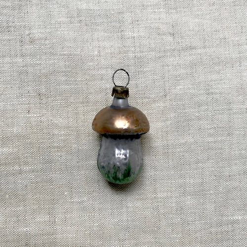 john derian Tiny Brown Mushroom Ornament Add to cart All Holiday ornaments and items are final sale and are not eligible for return or exchange.  Details 1" W x 2" H Glass Mouth-blown in Germany Item embraces vintage imper