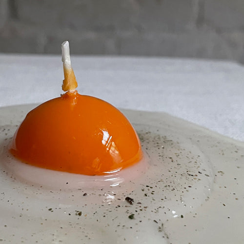 John Derian Uovo Fried Egg Candle Add To Cart Details 5.5" L X .75" H Paraffin Wax Each Item Will Feature Unique Variations Made In Italy Care Remove All Paper Before Burning. Not Intended For Children.   Cereria Introna Has B