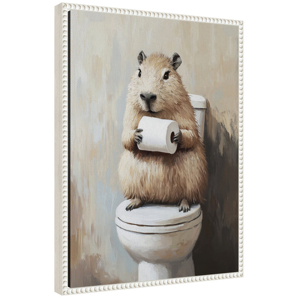 kate & laurel Sylvie Capybara Angled Holding Toilet Paper Roll Toilet Bathroom Art Framed Canvas by The Creative Bunch Studio