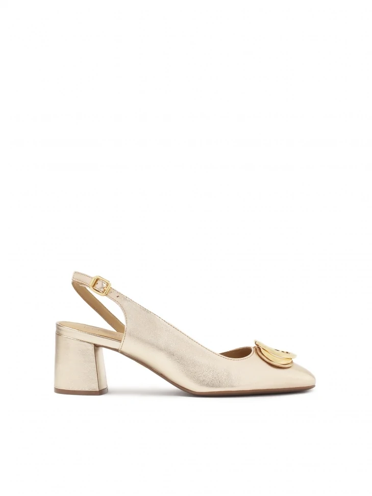 kazar Gold pumps with open heel and metal embellishment on the nose