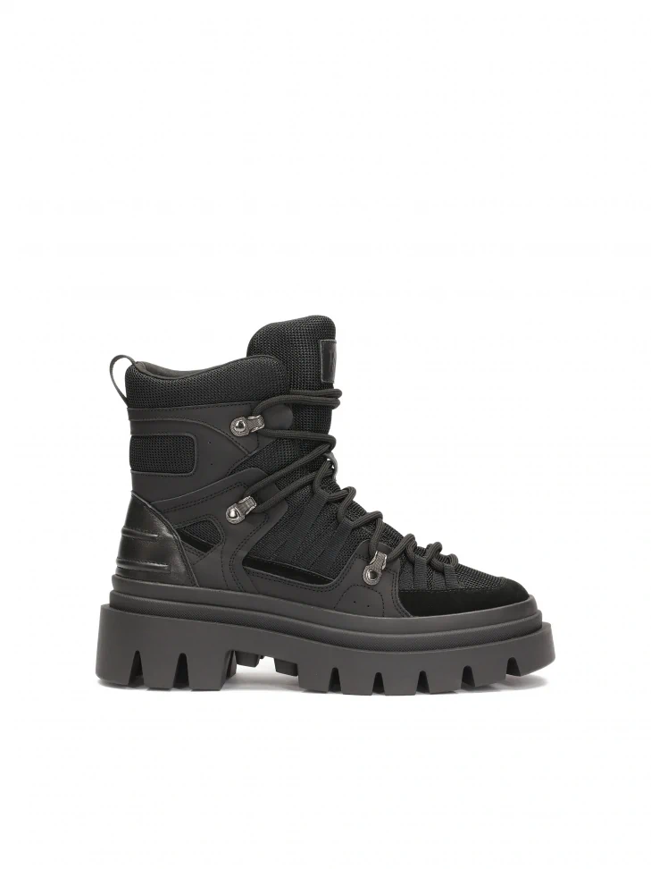 kazar Black boots on sole with trefoil