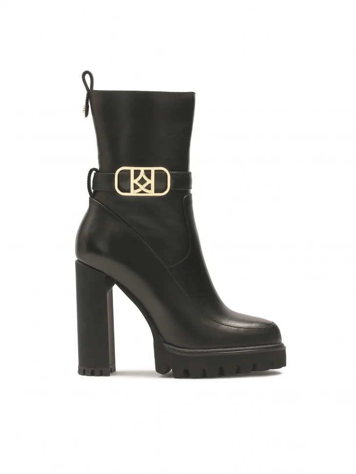 kazar Black monogrammed KAZAR boots set on a post