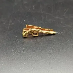 Gold tone revolver gun tie tack