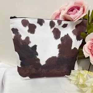 Makeup bag- cow print on canvas NIP open interior 7Hx8.75Lx2D” great gifts