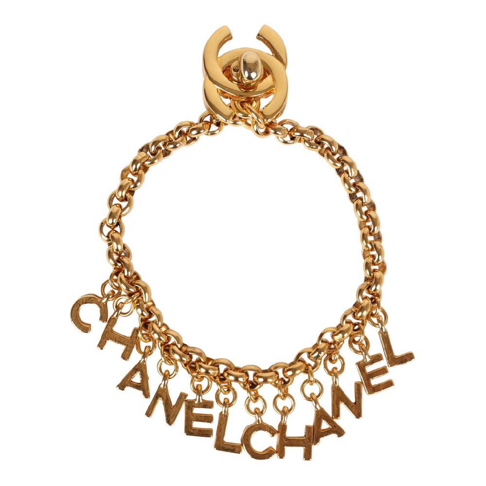 Vintage Chanel 24K Gold Plated "Chanel" Logo Charms Turnlock Bracelet