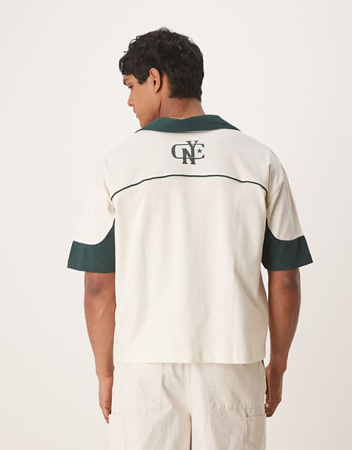 ASOS DESIGN Boxy Oversized Polo With Cut And Sew Panelling And City Graphics In Cream