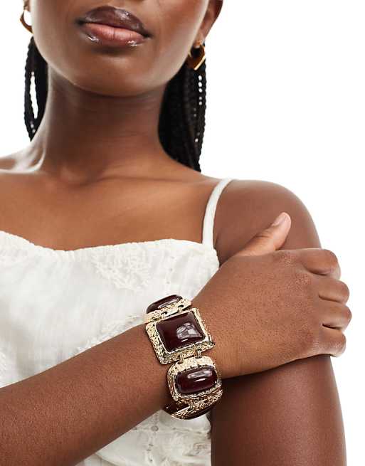 ASOS DESIGN bracelet with large burgundy stone-set detail in gold tone