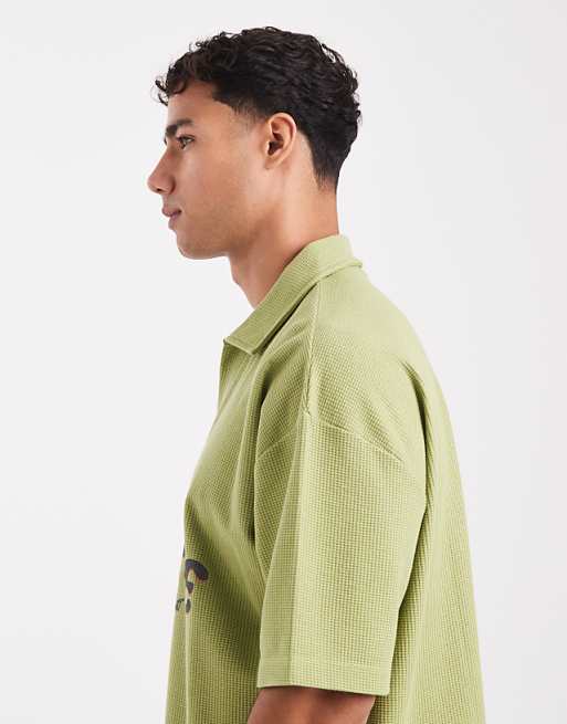 ASOS DESIGN Heavyweight Boxy Oversized Polo With Text Graphic In Green Texture