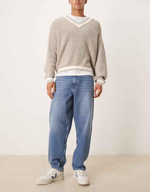 ASOS DESIGN loose straight fit jeans in midwash blue with raw hem styling