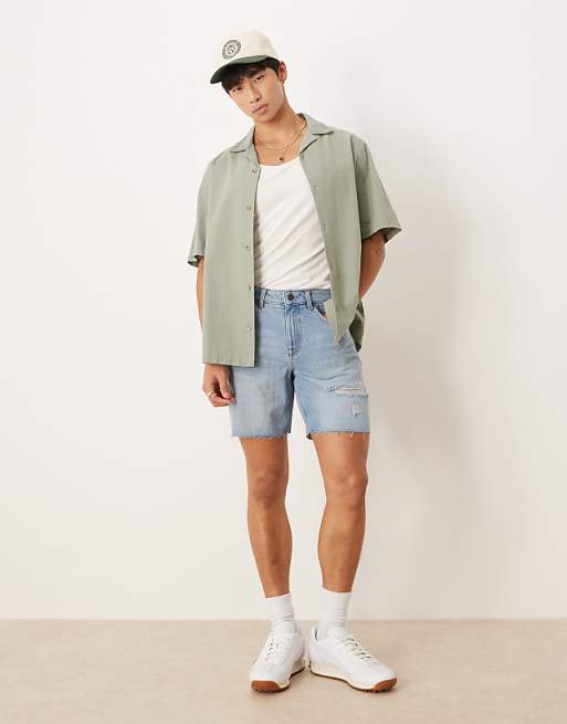 ASOS DESIGN mid length slim denim shorts with rips in light wash blue